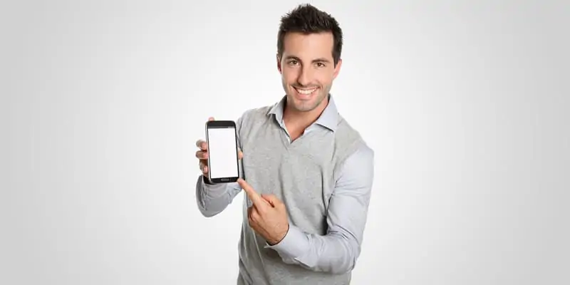 Person having a broad smile posing with a mobile in hand