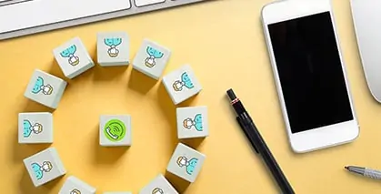 Cloud telephony solutions depicted with a phone icon cube in the middle surrounded by people with a mobile and pens beside