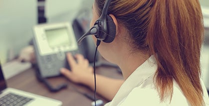 female telesales executive at work using audio conference solutions
