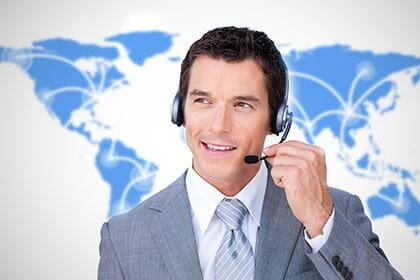 Man speaking through headphones in front of a world background to depict audio conferencing service